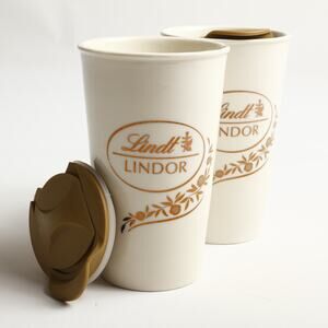 Pair of Lindt Lindor Ceramic Travel Mugs & Spill Resistant Lids White Gold